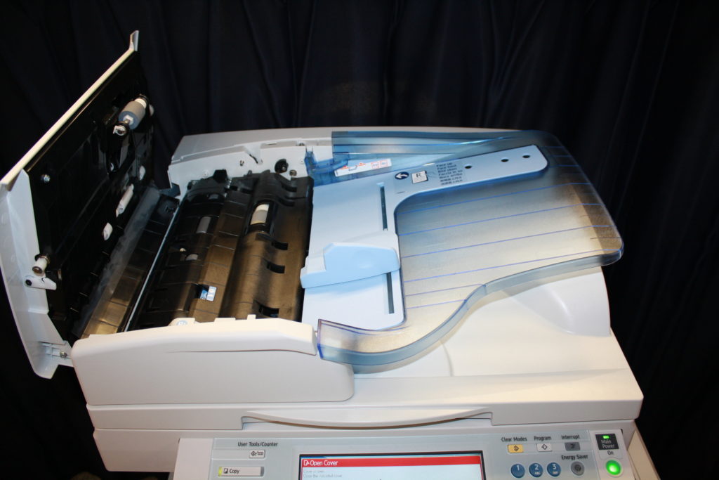 A printer with the lid open and its ink tray exposed.