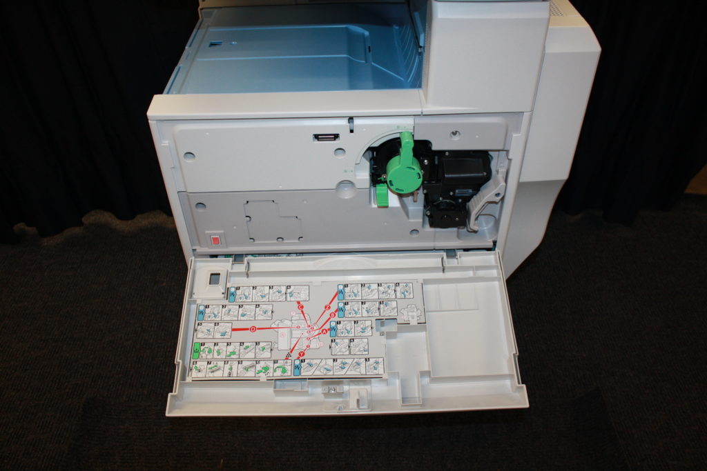 A printer with the lid open and some keys on it.