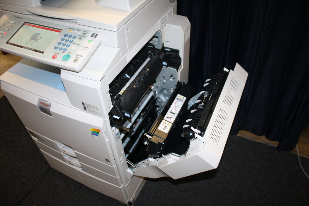 A printer that has been opened up to show the ink.