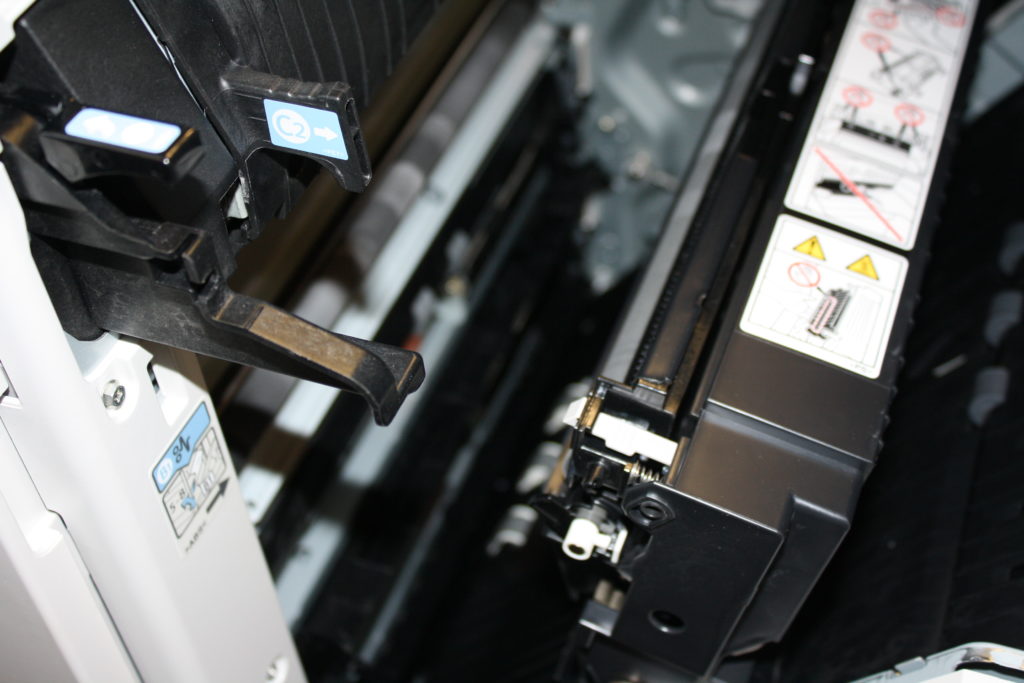A close up of the front part of an ink jet printer.