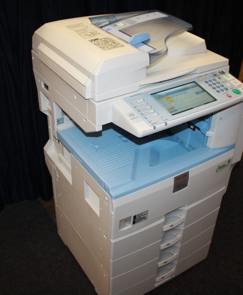 A printer that is sitting on top of some boxes.